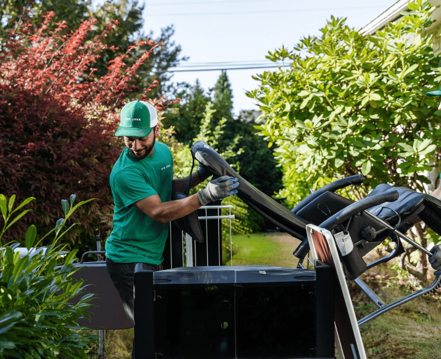 One of our 505-Junk team members carrying a chair during a furniture removal Vancouver job.