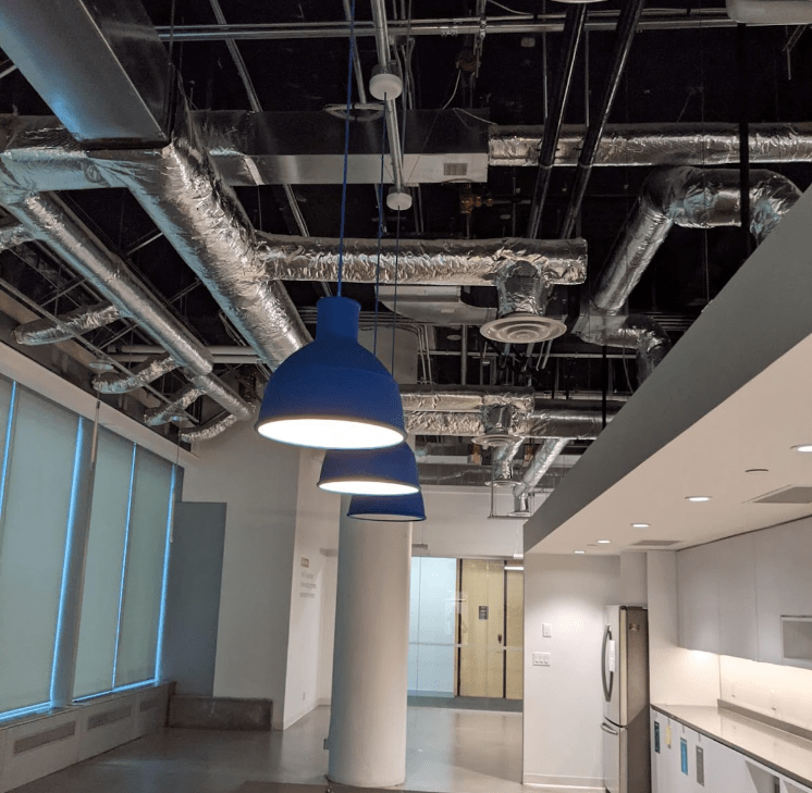An office space with lighting fixtures that are fit for donating construction material. 