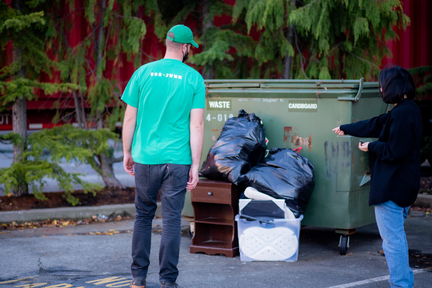 A 505-Junk employee completing junk removal for a property manager after somone dumped material by their dumpster.