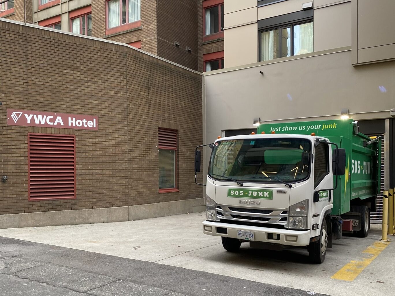 A 505-Junk truck in the loading bay of the YMCA Hotel during a hotel junk removal pickup.