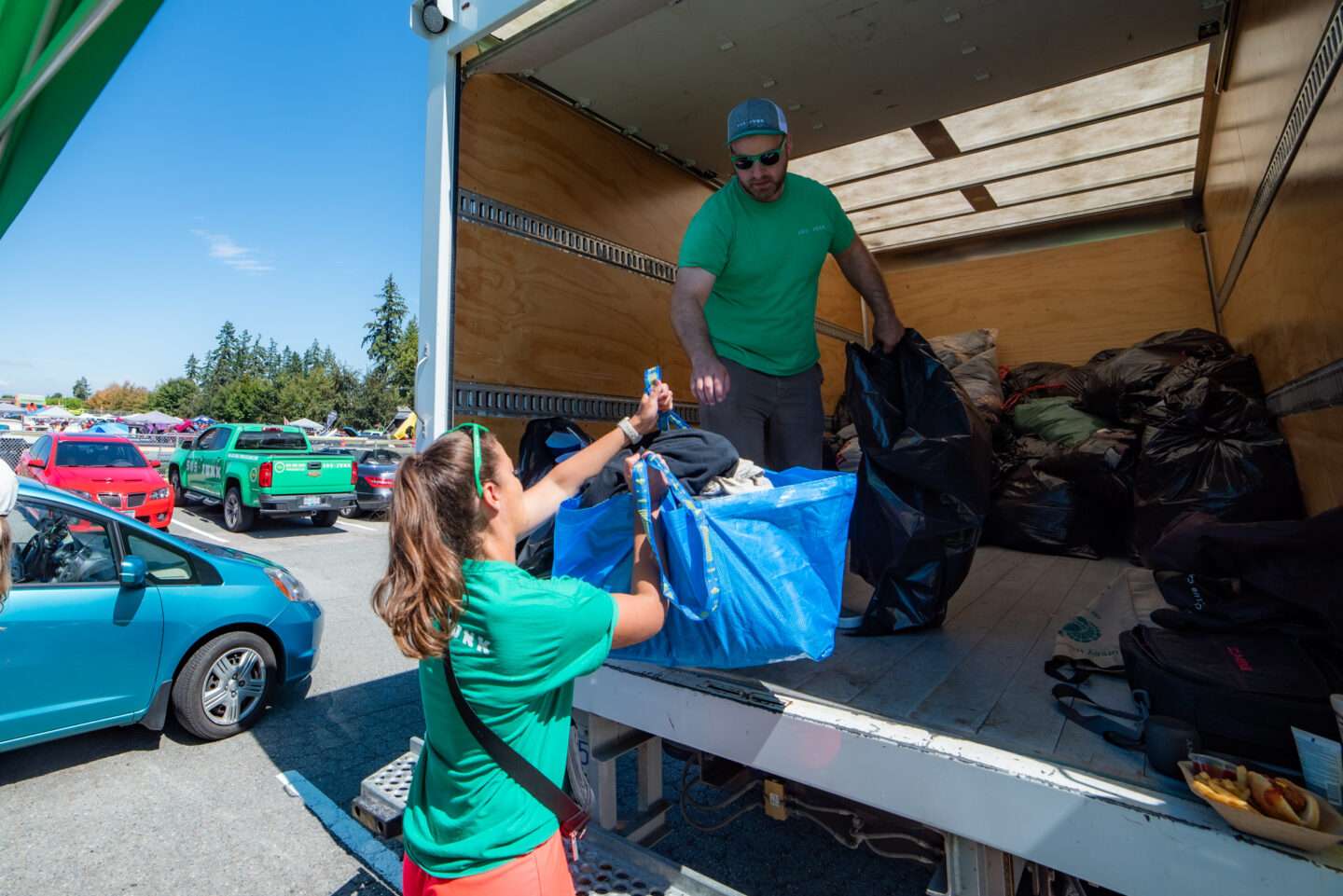 505-Junk employees loading the donation truck with reusable clothing that came from an apartment junk removal pickup. 