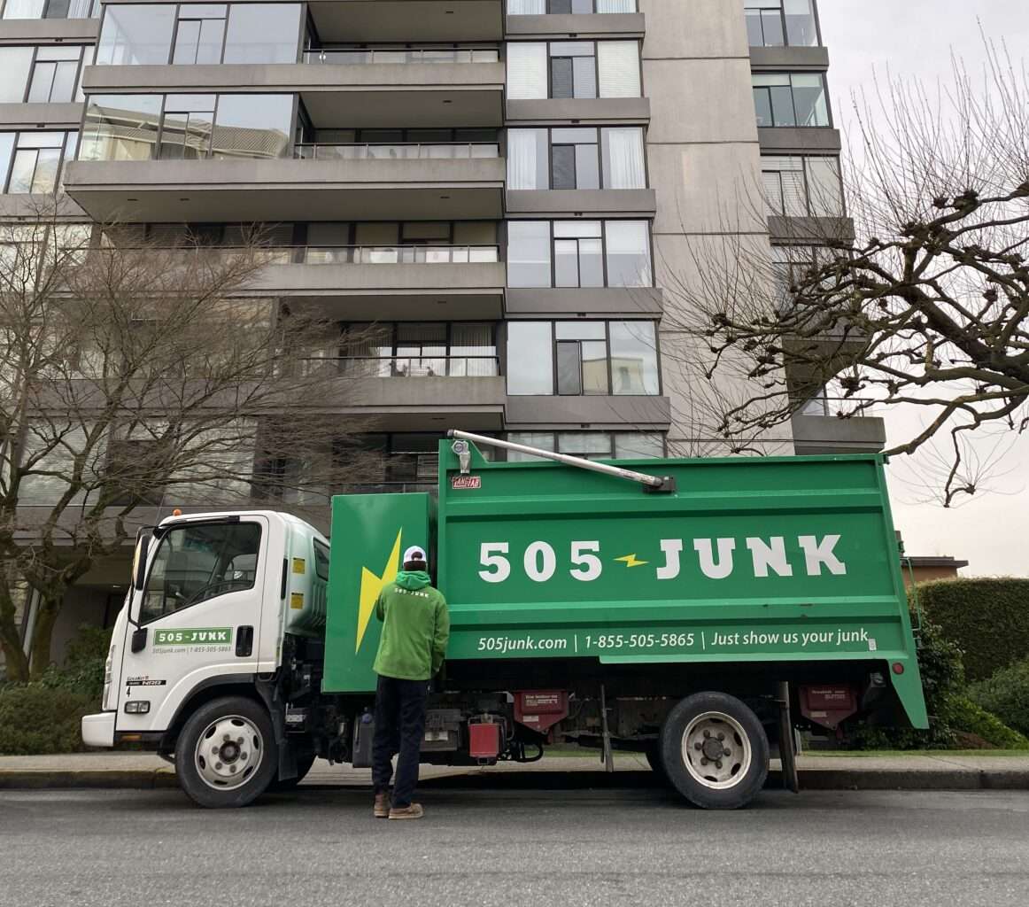a 505-Junk truck parked outside of an apartment building to complete a hoarding removal in Delta.