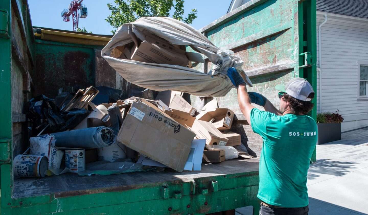 505-Junk team member throwing material into the back of the truck during a rubbish removal in Burnaby