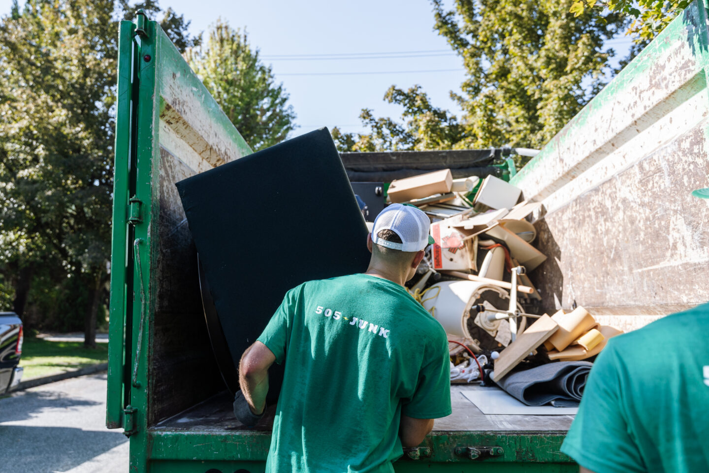 A 505-Junk employee loading the sofa into the truck during a couch removal in North Vancouver.