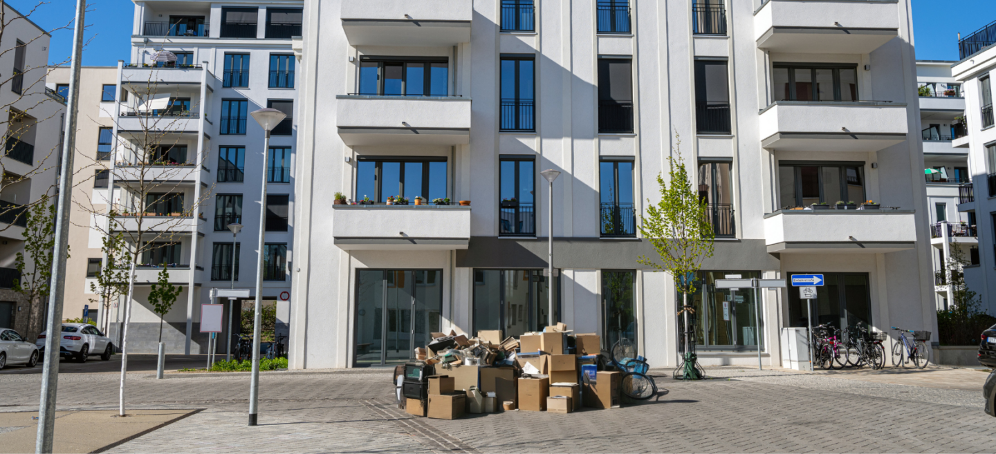 Junk removal for property managers: a pile of junk in front of a building.
