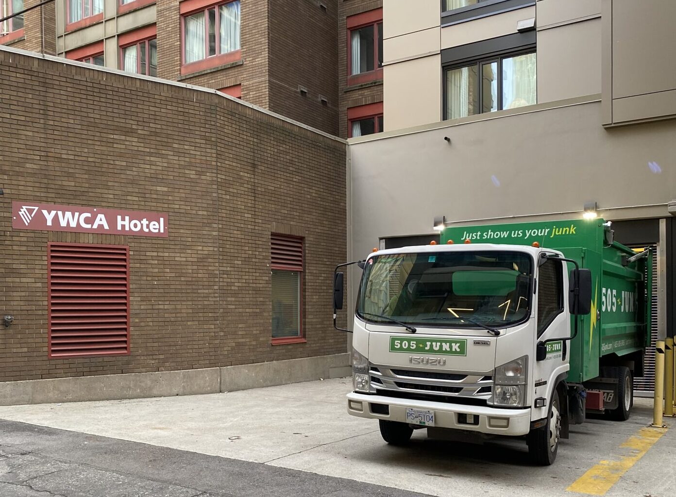 A 505-Junk truck in the loading bay of the YMCA Hotel during a hotel junk removal pickup.